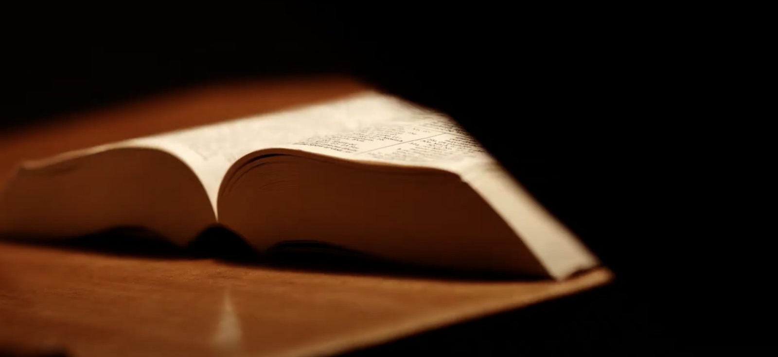 Open book lit by a single beam of light